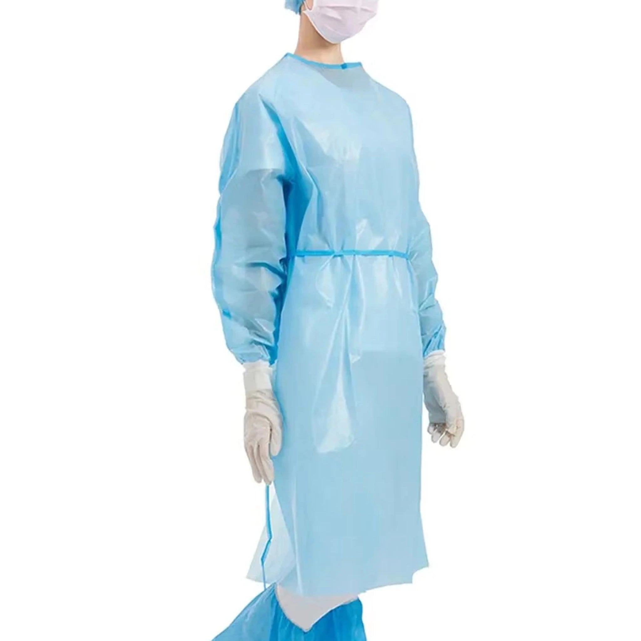 A person is shown wearing a disposable blue protective gown with long sleeves and elastic cuffs. The gown is designed to provide full-body coverage and protect against fluids, making it ideal for use in medical or hygiene-sensitive environments. The individual is also wearing blue gloves to enhance protection. Over white background.