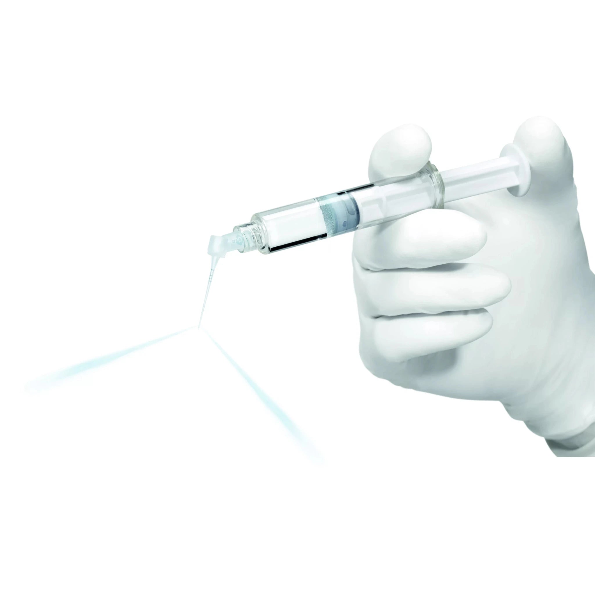 Close-up of a gloved hand holding a syringe fitted with an IrriFlex® flexible root canal irrigation needle, demonstrating precise irrigant delivery through two lateral vents for effective root canal cleaning