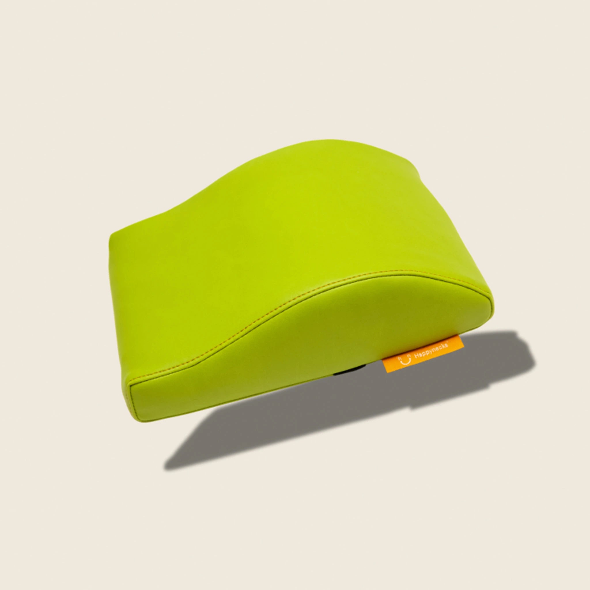 A bright green contoured support cushion, offering a vibrant color option along with its ergonomic design. Over white background.